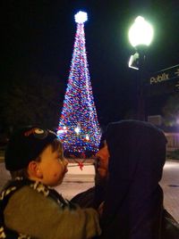 Illuminated christmas tree at night