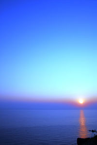 Scenic view of sea against clear blue sky