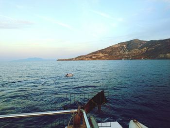 Cropped image of boat in sea against sky