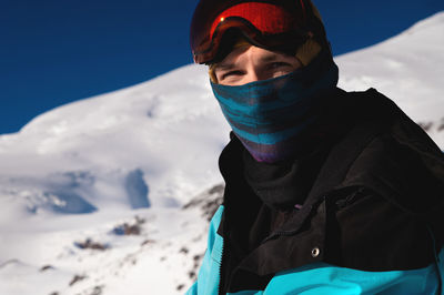 The skier looks at the camera before starting to ski. man enjoys vacation in winter season. portrait