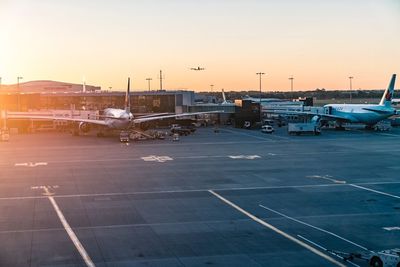 View of airport runway against sky during sunset