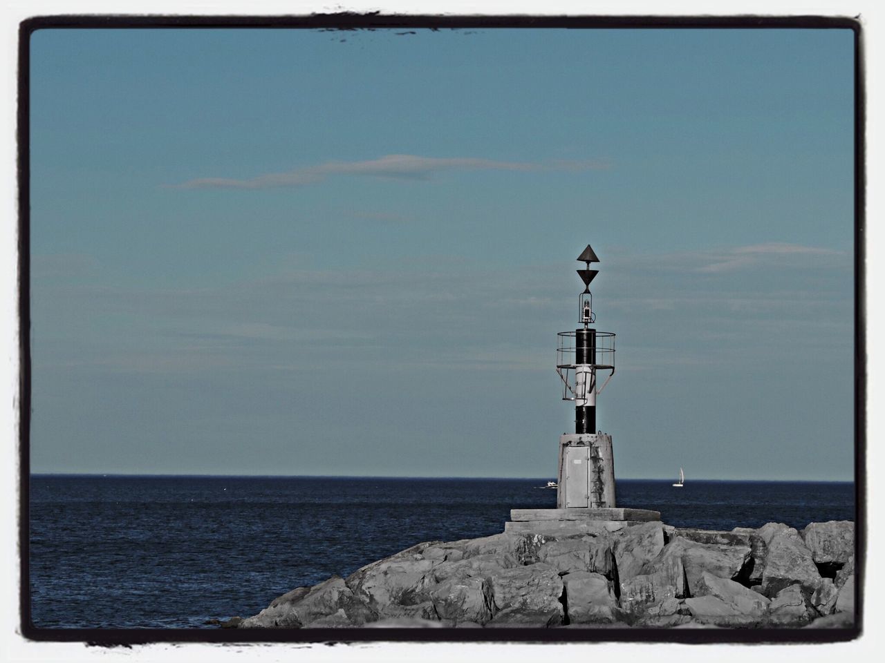 sea, horizon over water, transfer print, water, blue, tranquil scene, tranquility, scenics, clear sky, copy space, sky, auto post production filter, nature, beauty in nature, beach, rock - object, lighthouse, day, shore, outdoors