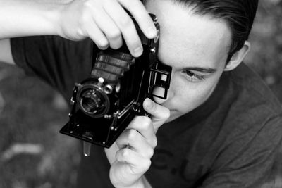 High angle view of man photographing through camera