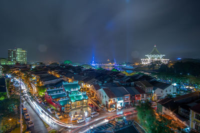 High angle view of city lit up at night