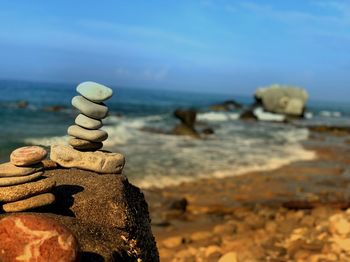 Close-up of stack of stones on beach