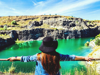 Rear view of woman looking at rocks
