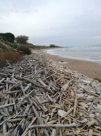 Stack of stones in sea against sky