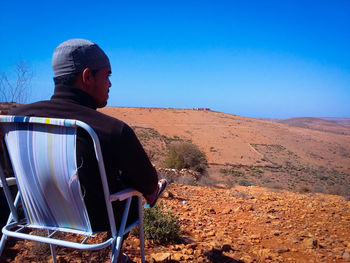 Rear view of man standing on landscape