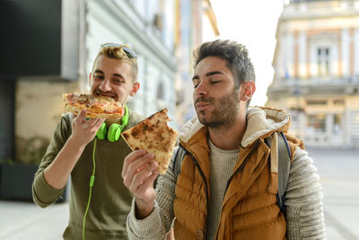 Male friends having pizza