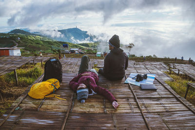 Couple relaxing on observation point during winter