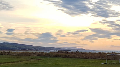 Scenic view of field against sky during sunset