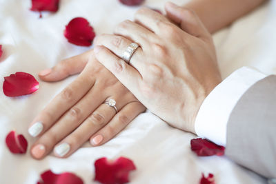 Midsection of couple holding hands