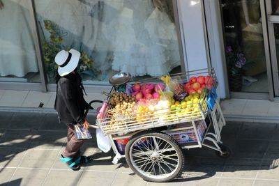 Woman with bicycle on flower in store