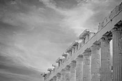 Low angle view of building against cloudy sky