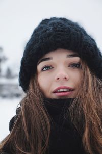Close-up portrait of teenage girl wearing knit hat during winter