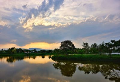 Scenic view of lake against sky at sunset