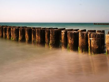 Pier over sea against clear sky