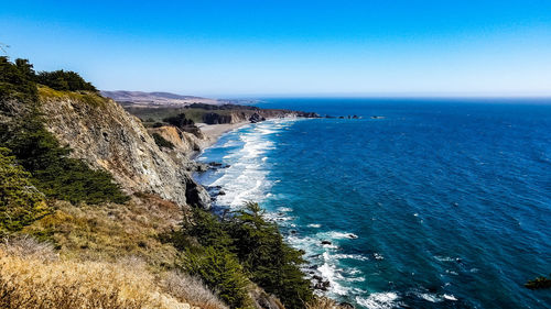 Scenic view of sea against clear blue sky