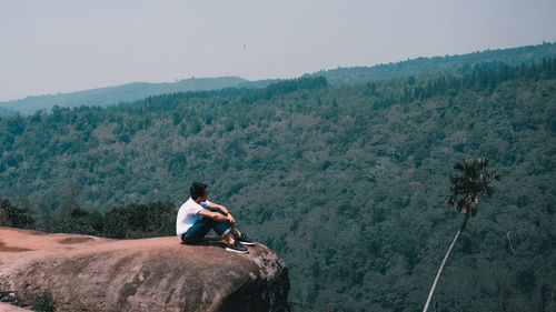 Man sitting on rocky mountains