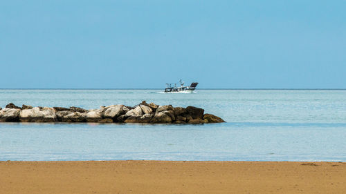 Scenic view of sea against clear blue sky