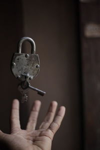 Close-up of human hand holding metal