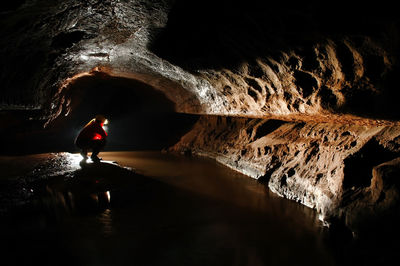 Silhouette man standing in cave