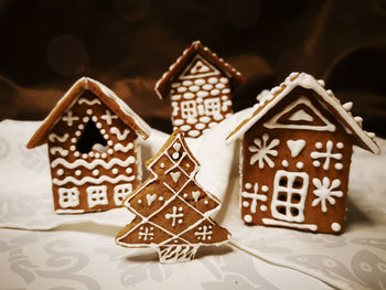Gingerbread houses and christmas tree decorated with white glaze in new year and christmas patterns