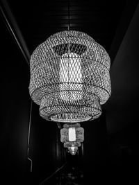 Low angle view of illuminated pendant lights hanging from ceiling