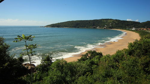 View of calm beach against blue sky