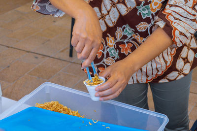 High angle view of woman eating food on table