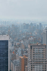 High angle view of buildings in city against sky