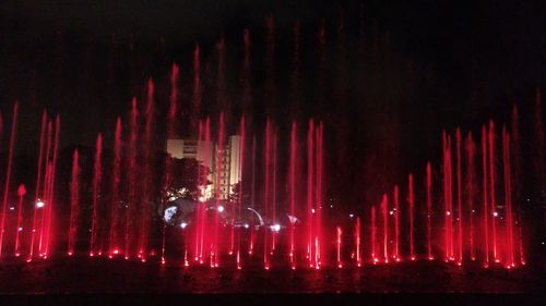 Low angle view of illuminated fireworks against sky at night