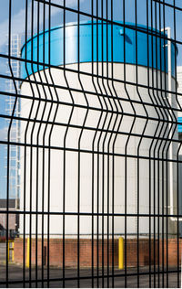 Modern building against sky seen through glass window