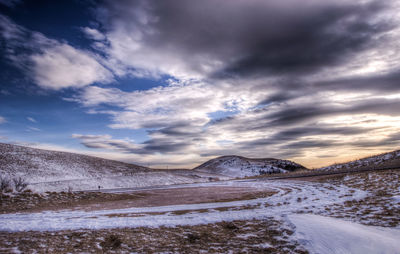 Scenic view of landscape against sky during winter