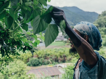 Portrait of man against plants