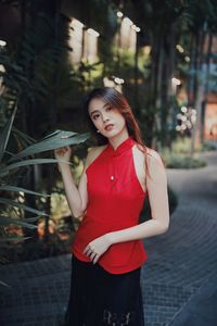 Portrait of smiling young woman standing outdoors
