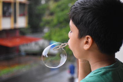 Portrait of boy holding bubbles