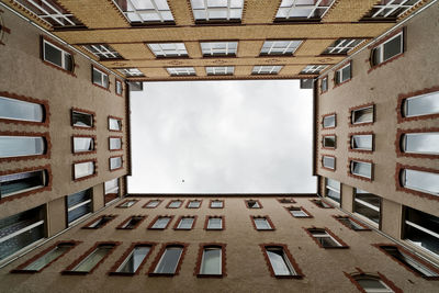 Low angle view of apartment building against sky