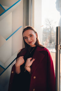 Portrait of smiling young woman standing in winter