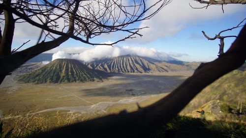 View of volcanic landscape against cloudy sky