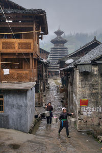 People walking by buildings in city