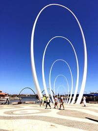 Man riding bicycle against clear blue sky