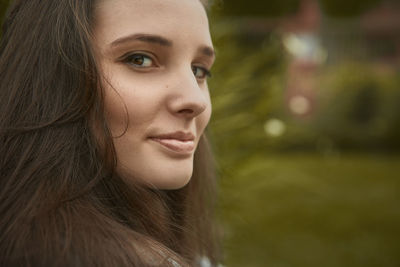 Close-up portrait of beautiful young woman with brown hair