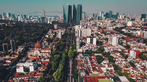 High angle view of modern buildings in city against sky