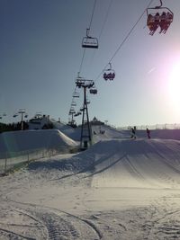Ski lift against clear sky during winter