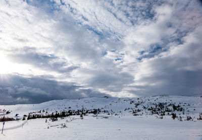 Scenic view of snow covered mountains against sky