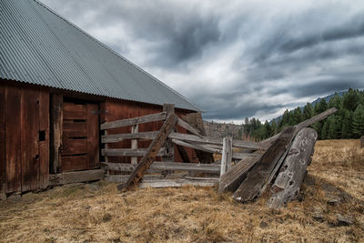 Abandoned wood on field against sky