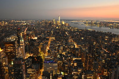 High angle view of city lit up at night