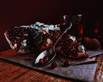 Close-up of pomegranates and spoon on table