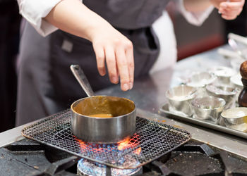 Midsection of man preparing food